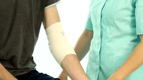 Physiotherapist remove bandage from patient arm movie

