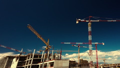 Big construction site with cranes with pan and zoom effect.