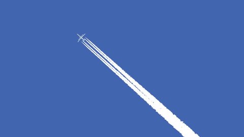 Jet airplane with trail against the blue sky