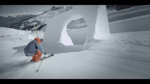 A skier passes through a snowy archway while skiing down a snowy mountain slope, close-up Editorial Stock Video