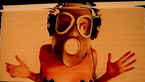 sexy woman with beautiful body dances with a gas mask covering her face. Good clip for party, fetish, industrial or warfare. Intentional added video distortion
