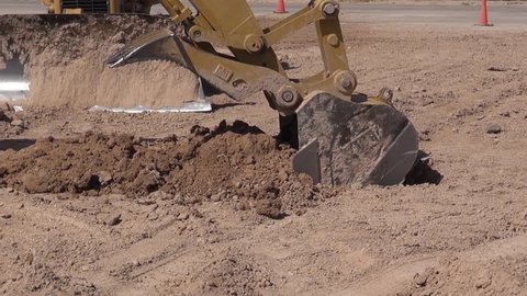 Las Vegas United States June 4 2014: Filming a safety video of the desert turtoise that is an endangered species an excavator at a construction site in Las Vegas picks up dirt and drops it.