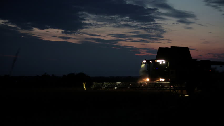 Combine harvester drives across a rapeseed field at dusk. Filmed mid-summer in Norfolk, England. 
Shot and exported in ProRes 422. | Shutterstock HD Video #6920593