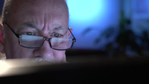 Frustrated older man at computer, close up