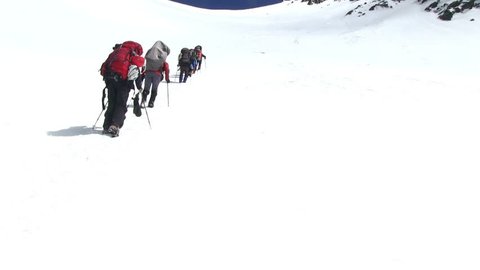 Climbers go up to the mountain pass