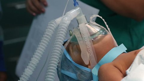 Unidentified Child with an oxygen mask on a critical surgery