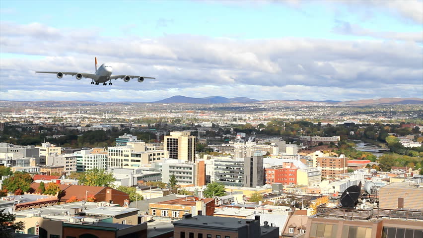 A jumbo jet flying at low altitude over a big city.  (3d animation)