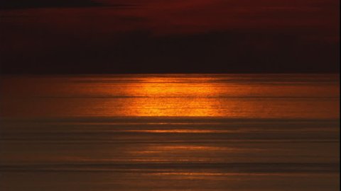 Reflection of an orange sunset on the ocean at sunset