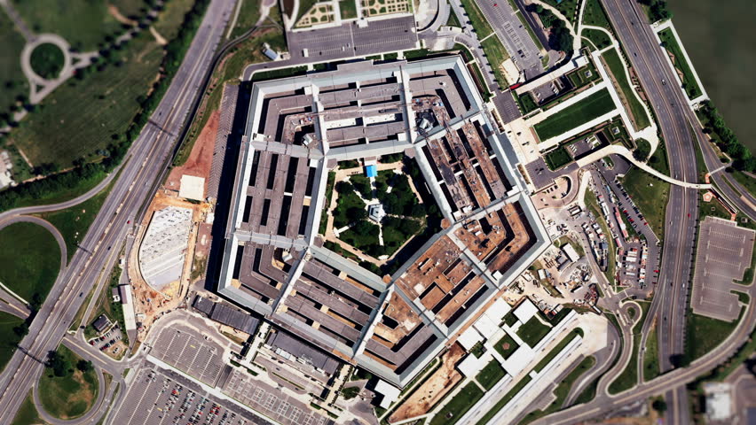 Satellite Zoom into U.S. Pentagon (30fps). A slow aerial zoom in on the United States Pentagon building in Arlington, Virginia, shot from a satellite perspective above with moving clouds and traffic.