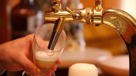 Tapping a beer in a bar - original footage, not color corrected.