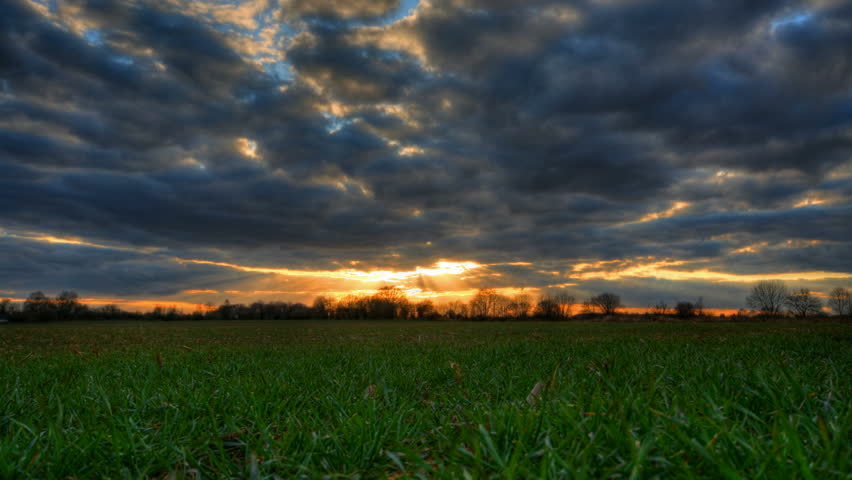 Sunset over grass field, HD time lapse clip, high dynamic range imaging