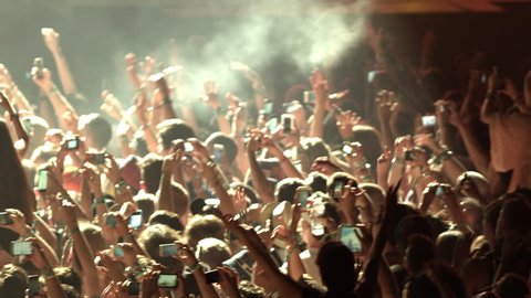 Crowd at Concert - Fans Cheering in Audience with Smartphones in Music Show at Coachella in Slow Motion