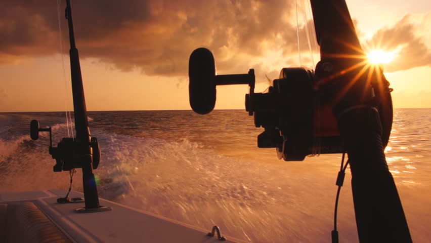 Saltwater fishing in Florida Keys, Boat heading offshore at sunrise.