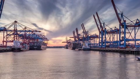 HAMBURG, GERMANY - JULY 22: Timelapse of Container Terminals in the port during Sunset. on July 22rd, 2014 in Hamburg