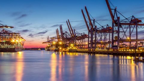 HAMBURG, GERMANY - JULY 22: Timelapse of Container Terminals in the port during Sunset. on July 22rd, 2014 in Hamburg