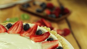 A woman baking a fresh berry fruit tart in her kitchen for desert - Powered by Shutterstock - Get 15% off with code: PIKWIZARD15