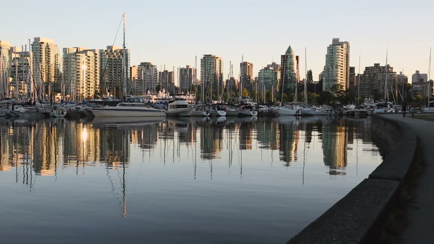 Downtown Vancouver Evening Coal Harbor dolly shot. Looking across Coal Harbor from Stanley Park at the Downtown Vancouver skyline at sunset.