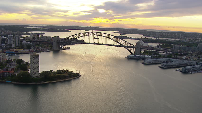 Wide aerial shot of the Sydney Harbour Bridge from west to east / south WITH Circular Quay, Botanic Gardens, CBD,  Milson's Point, Luna Park, Walsh Bay, Farm Cove & Potts Point