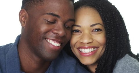 African American couple in love smiling and looking at camera