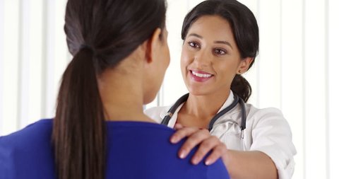 African American patient talking to Hispanic doctor