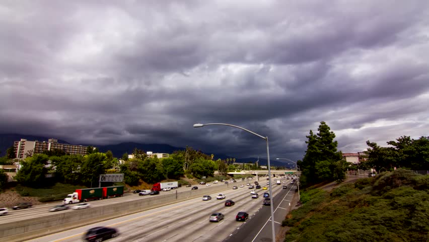 Time lapse of stormy clouds over highway