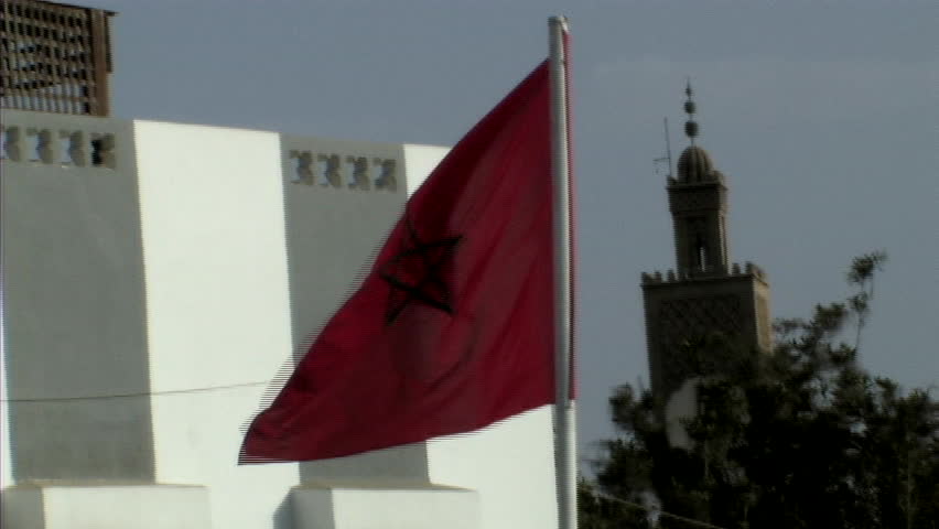 Moroccan flag with mosque in background