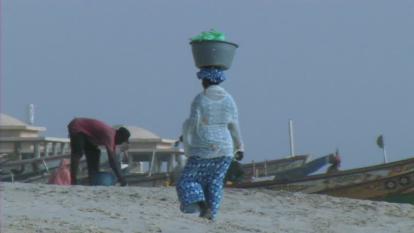 woman walking on beach in africa