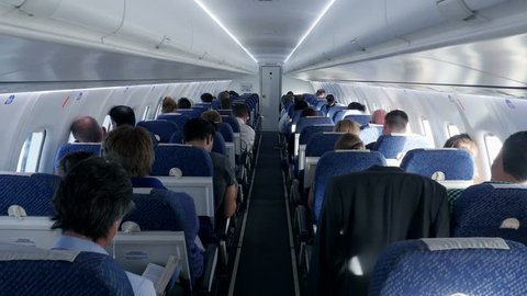 inside airplane. passengers siting in plane. air travel. flight flying. business trip. vacation