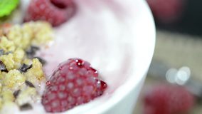 Homemade Raspberry Yogurt in a bowl (rotating; not loopable)