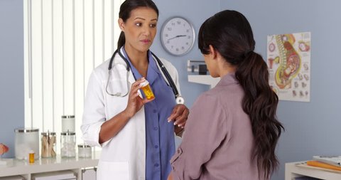 African American OBGYN talking about prescription to patient