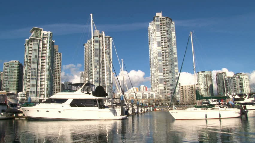 Beautiful day as sailboat enters docks in Vancouver, Canada near the Yaletown