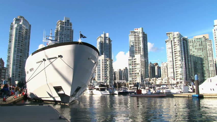 City scenic with large yacht in Vancouver, Canada near the Yaletown Marina.