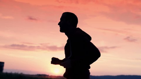 silhouette of man jogging in the country super slow motion, 240Fps
