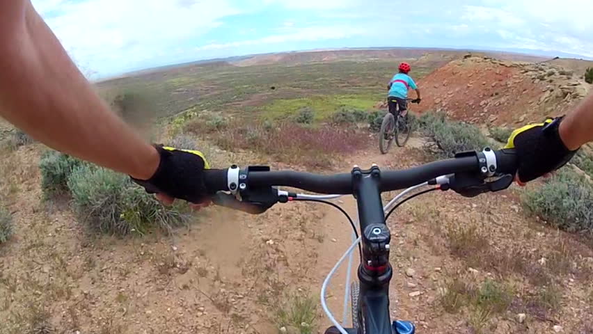 Mountain biker follows another on ridge