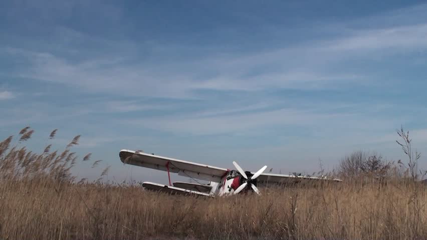 Old crashed air-plane in a field time lapse   