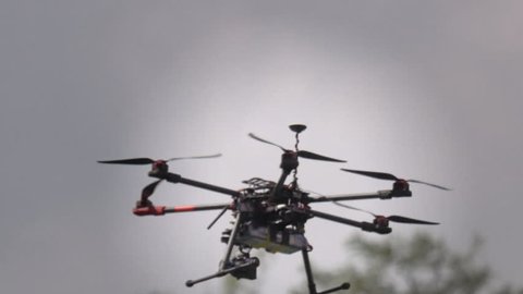 Professional drone flying with GPS making a ride over the forest