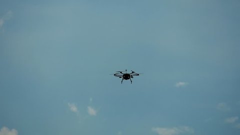 Professional drone flying in the air, in a aerial shot, 4k.