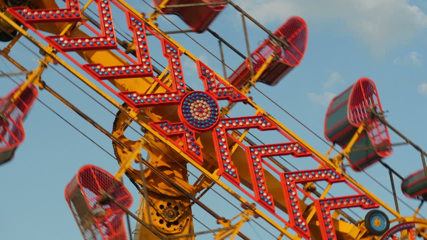 The Zipper carnival ride spins against the sky during the 2014 New Jersey State Fair at the Sussex County Fairgrounds in Augusta, New Jersey. Royalty-Free Stock Footage #7011334