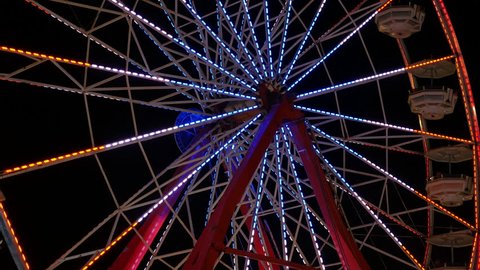 The colorfully illuminated Gentle Giant Ferris Wheel spins against the night sky during the 2014 New Jersey State Fair at the Sussex County Fairgrounds in Augusta, New Jersey.