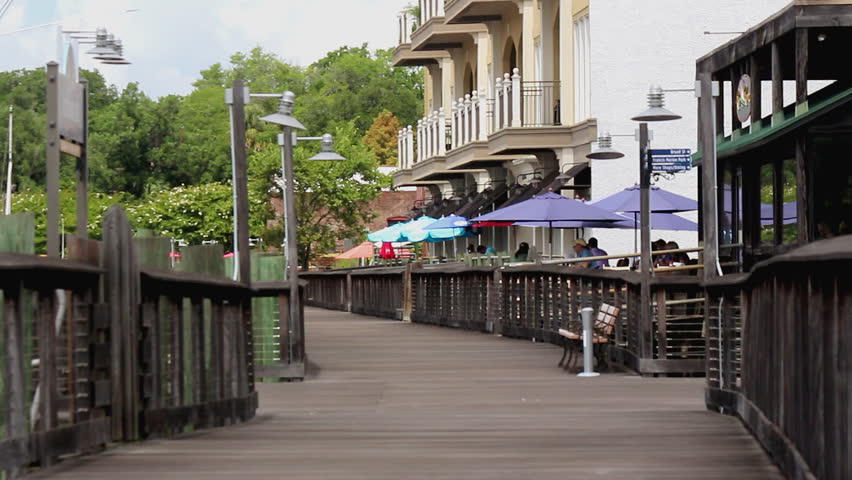 A boardwalk along a harbor in a historic city