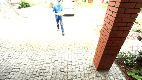 Man delivering a package and asking for a signature film 
