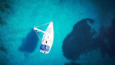 Yacht in amazing clear sea / ocean - water - taken from top by drone