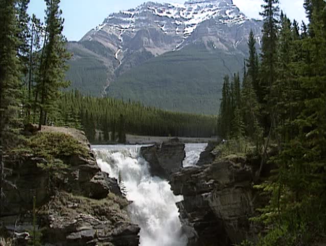 Athabasca Falls in front of mountain scenery, Jasper National Park, Canada