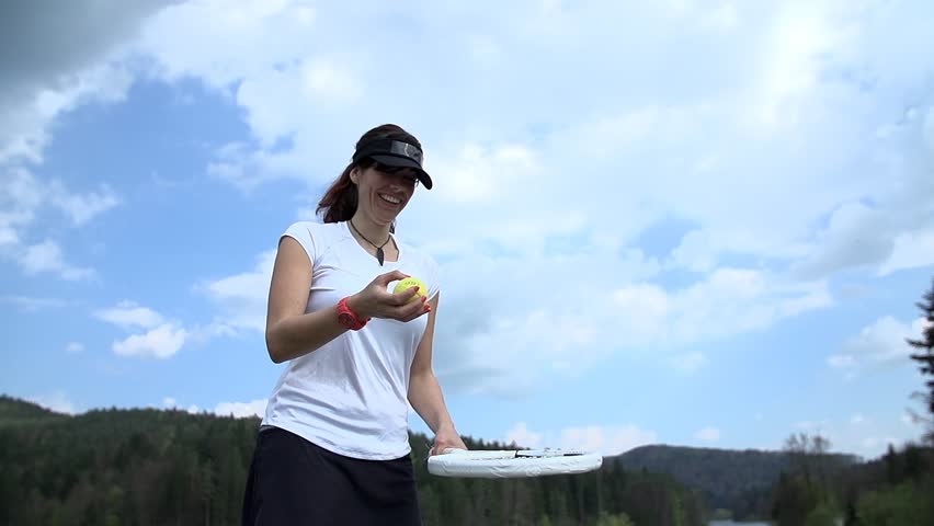 Tapping tennis ball with racket in slow motion