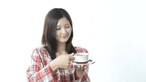 Asian woman drinking cup of coffee