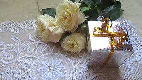 White roses with present and heart red box. Party decoration. Celebratory video. 