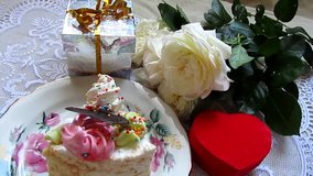 Birthday cake, roses flowers and gifts. Party decoration. Celebratory video. 
