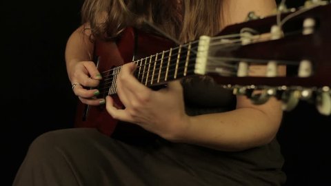 Female hands playing the guitar
