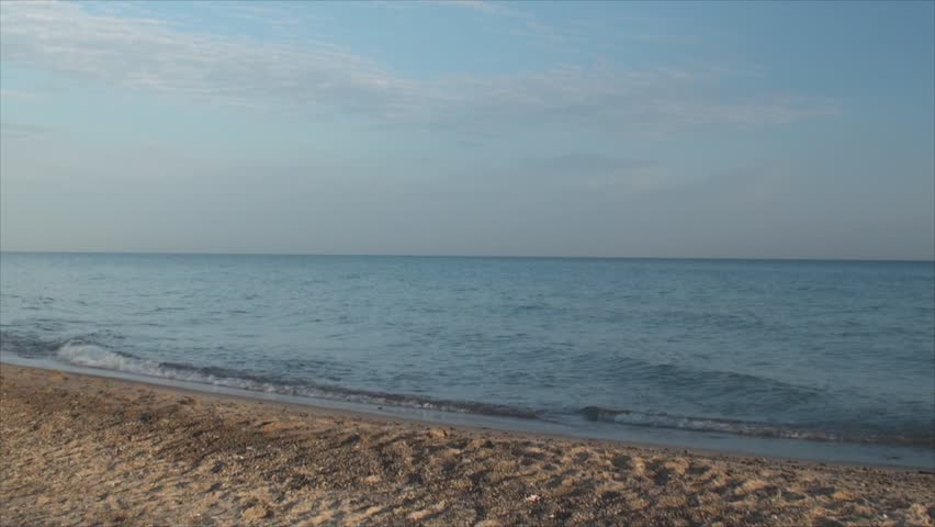 Woman in black runs through lake beach 2. Early morning footage.