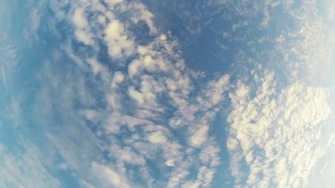 Beautiful white clouds soar across the screen in time lapse fashion over a deep blue background.